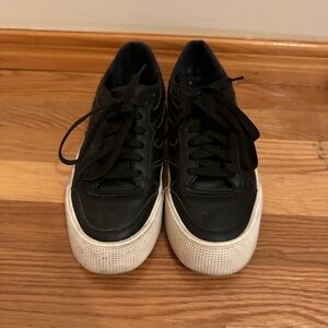 Black leather sneakers with white soles